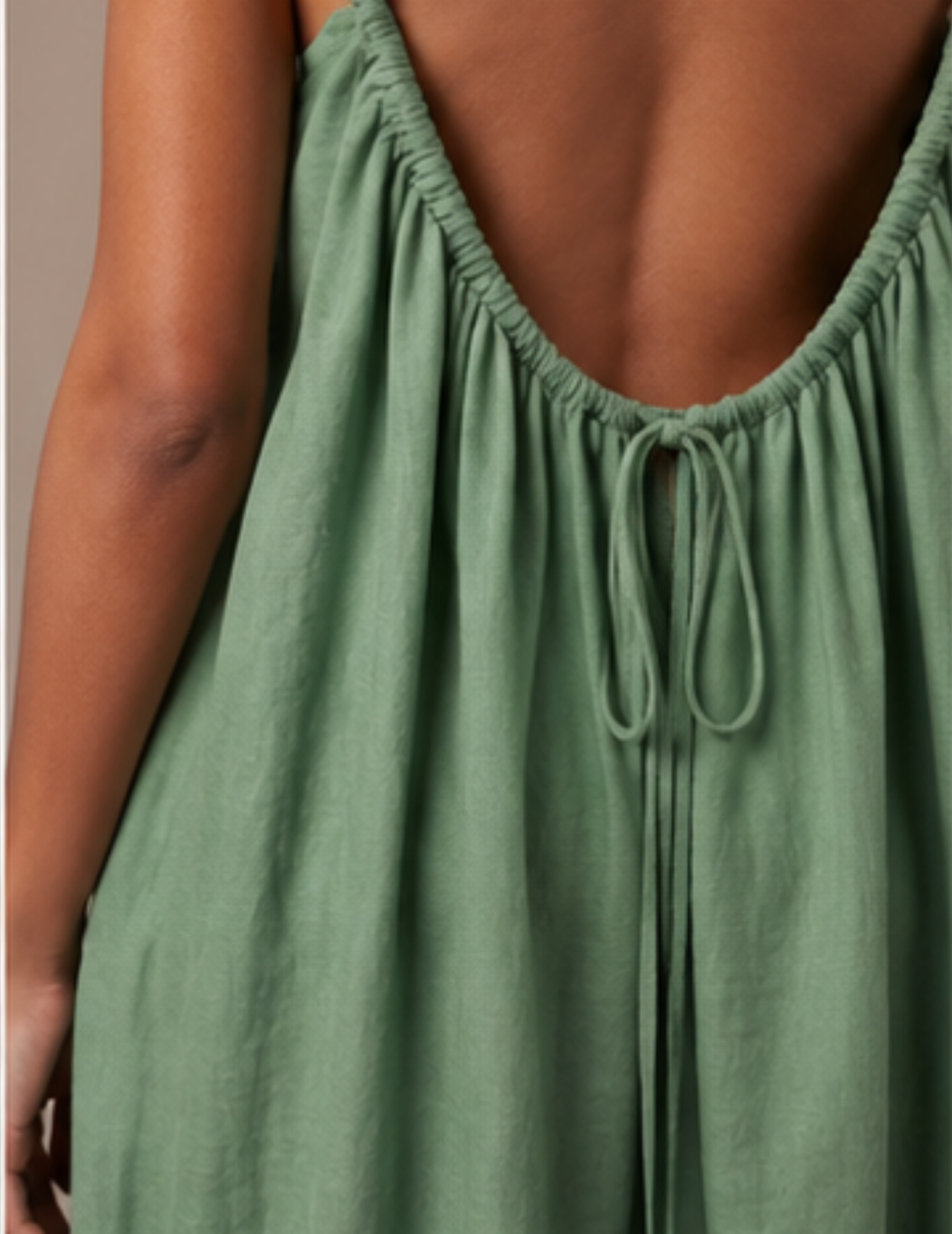 Close-up of the low 
open back with 
adjustable drawstring 
tie and tassels on the 
Amazonie maxi dress 
sewing pattern