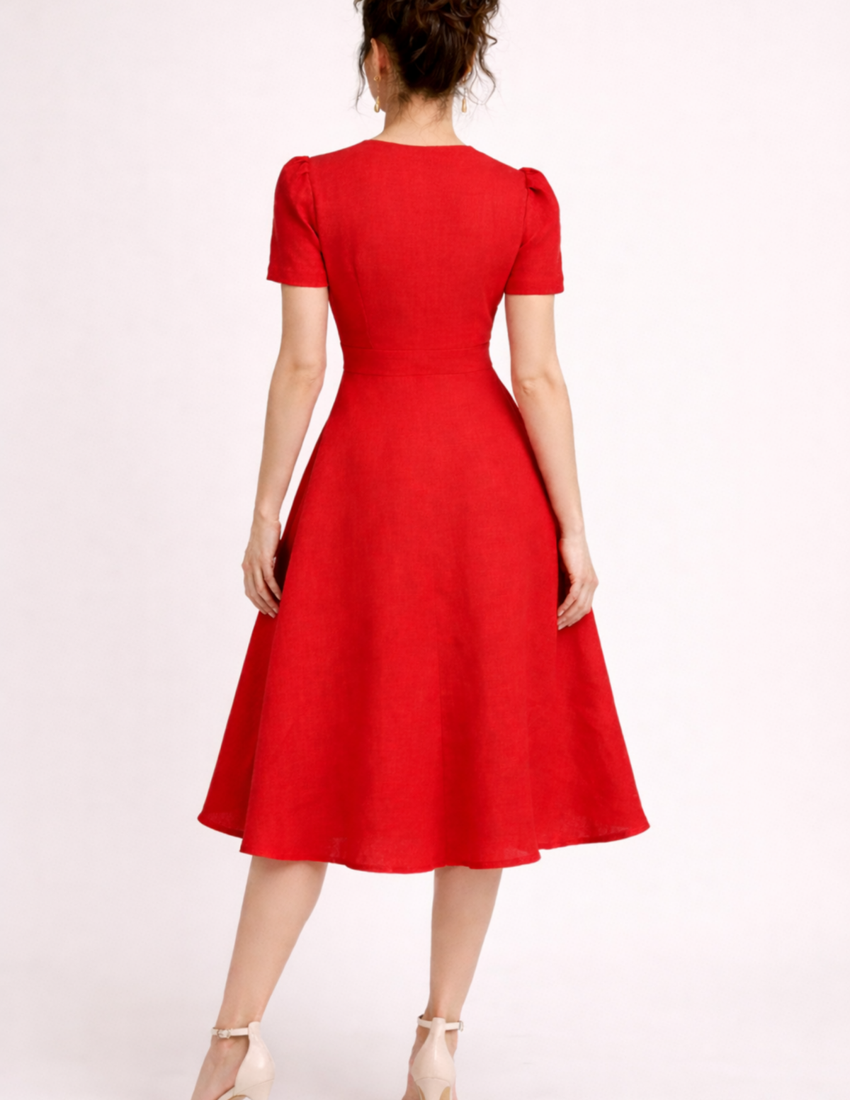 FAYA women's dress sewing pattern shown from the back, featuring a fitted bodice, defined waist and flowing flared midi skirt in red linen fabric.