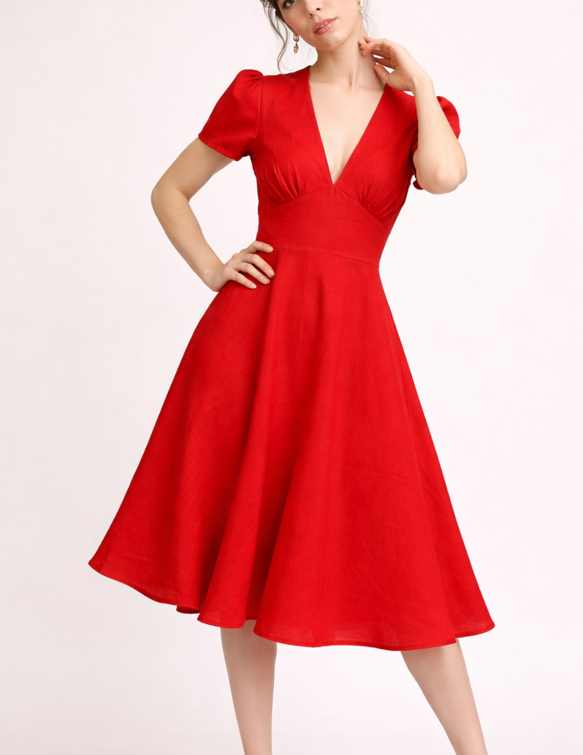 FAYA women's dress sewing pattern sewn in red linen, featuring a deep V-neck, gathered bust, puff sleeves, fitted waist and flowing midi skirt.