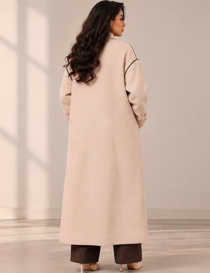 Back view of the Marlie women's long 
coat sewing pattern, showing the clean 
back silhouette, dropped shoulders, long 
sleeves and midi-length coat design
