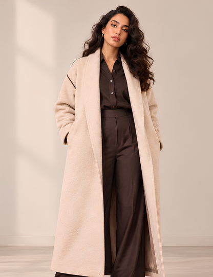 Marlie women's long coat sewing 
pattern shown from the front, featuring 
a long relaxed silhouette, shawl collar, 
dropped shoulders, long sleeves and side 
seam pockets.
