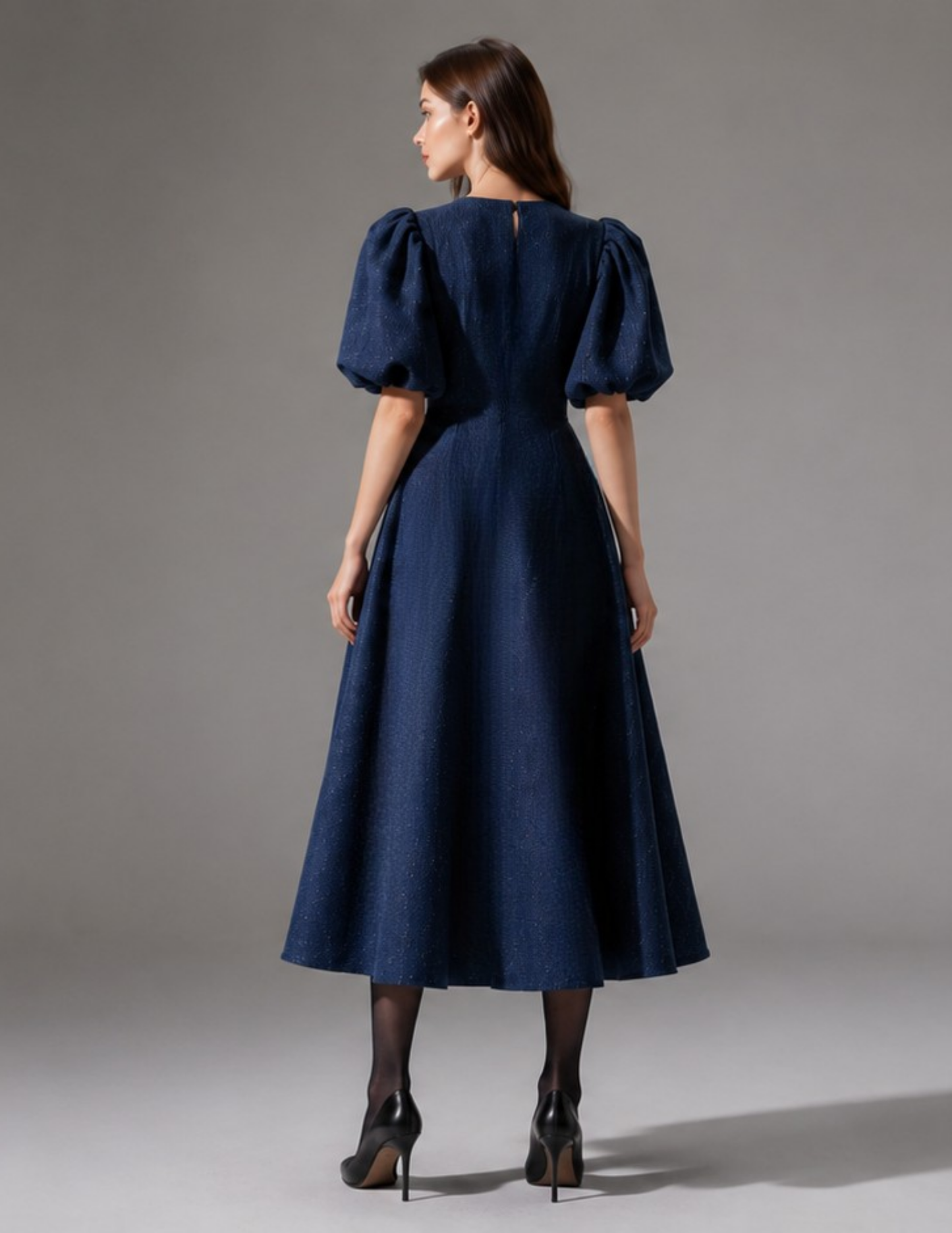 Back view of the OLGA dress showing the fitted waist, puff sleeves and back neckline opening