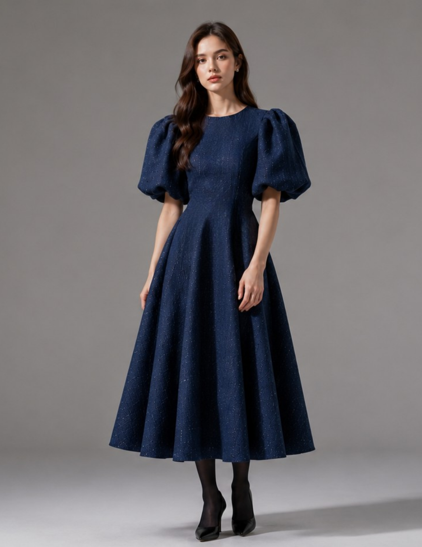 Front view of the OLGA dress featuring oversized puff sleeves, fitted waist and flared midi skirt