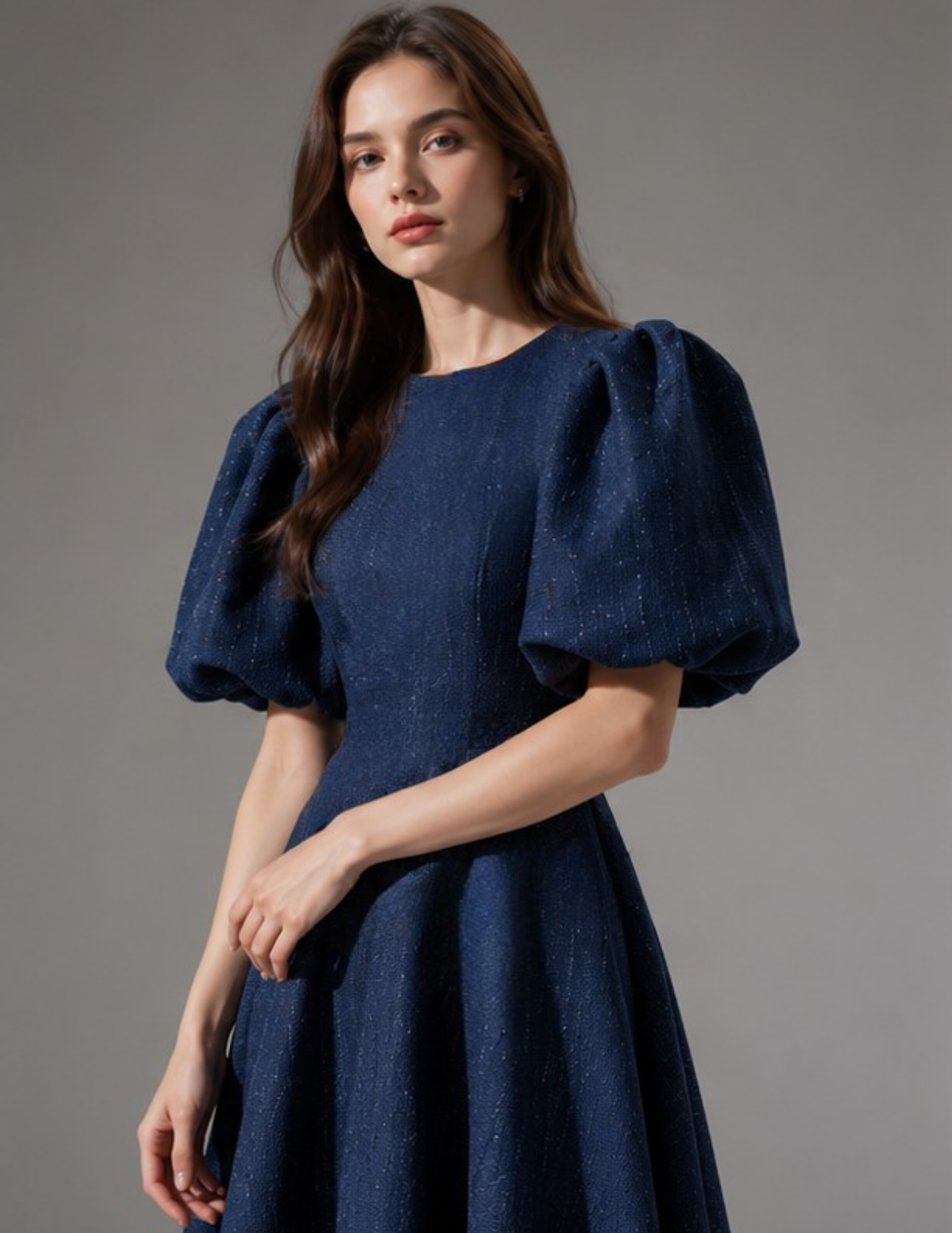 Close-up of the OLGA dress bodice showing the round neckline and oversized puff sleeve details