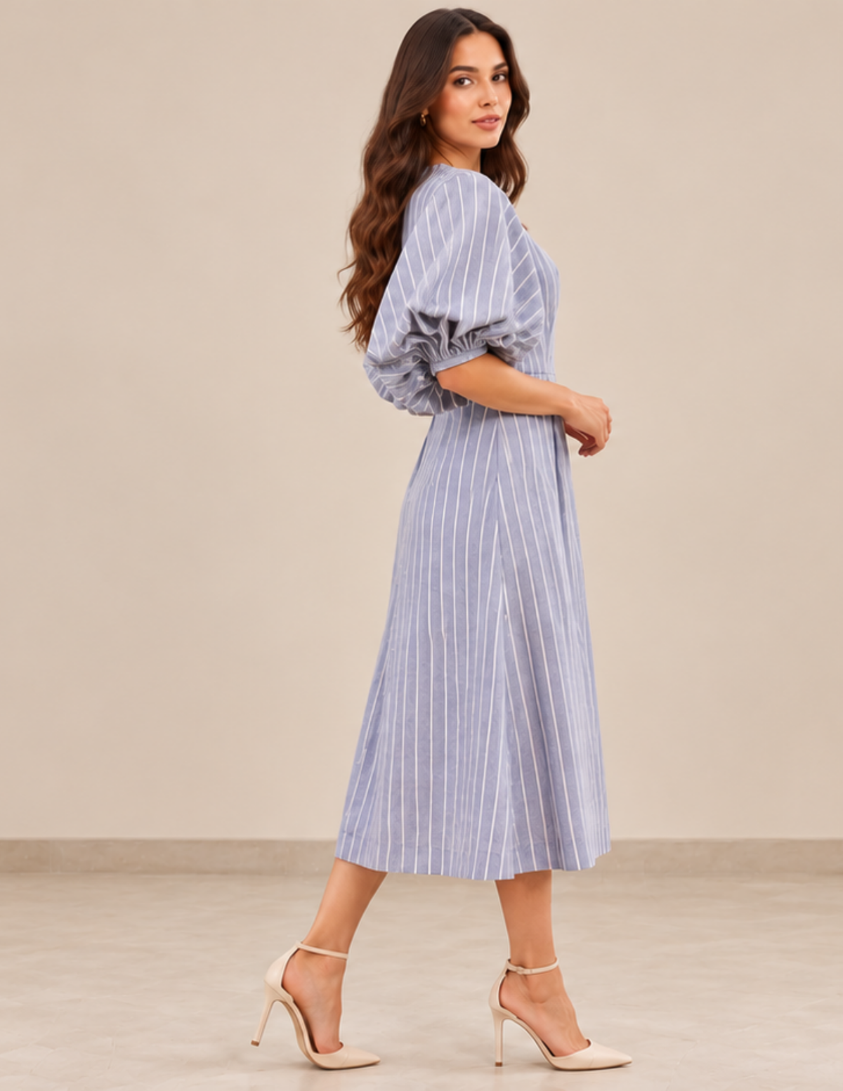 Side view of the PILAR women's puff sleeve dress with a fi tted waist, blue vertical stripes and a fl owing A-line midi skirt