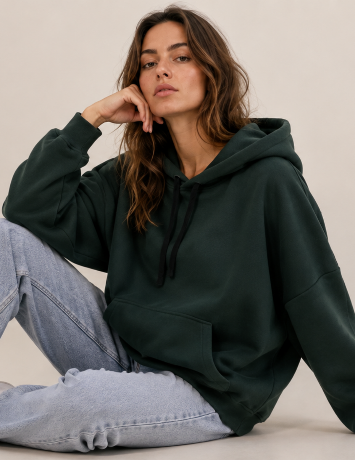Women's VERNA hoodie sewing 
pattern shown in dark green fleece 
with a kangaroo pocket, hood with 
drawstring, and relaxed everyday fit